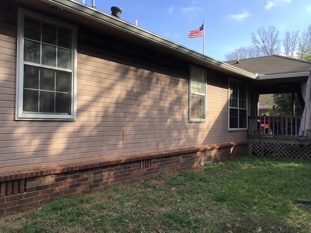 view of property exterior with a yard