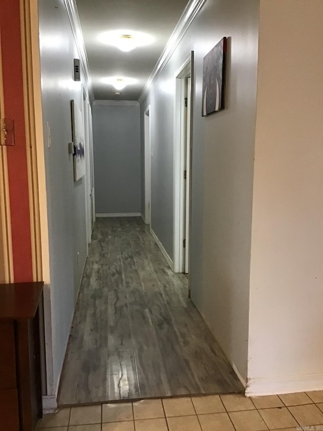 hallway featuring ornamental molding and tile patterned floors