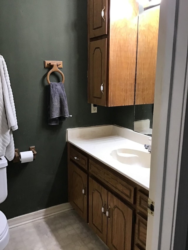 bathroom featuring vanity and toilet