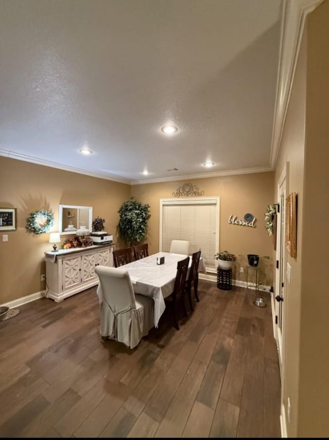 dining space featuring baseboards, dark wood finished floors, crown molding, and recessed lighting