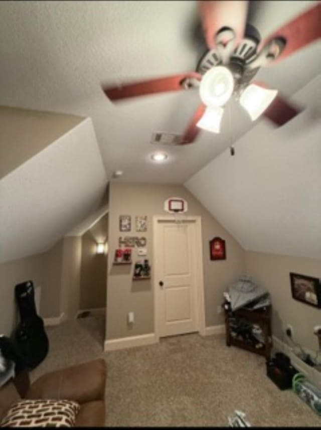 additional living space with lofted ceiling, ceiling fan, baseboards, and carpet flooring