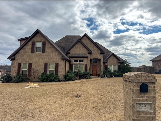 view of front of property with a front yard and brick siding