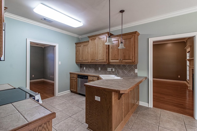kitchen featuring sink, decorative light fixtures, stainless steel dishwasher, and light tile patterned floors
