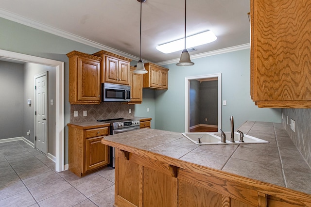 kitchen featuring sink, light tile patterned floors, hanging light fixtures, stainless steel appliances, and tasteful backsplash