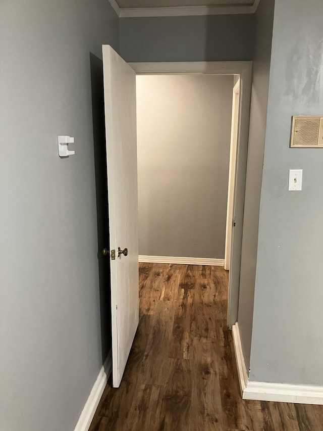 hall with dark hardwood / wood-style flooring and ornamental molding