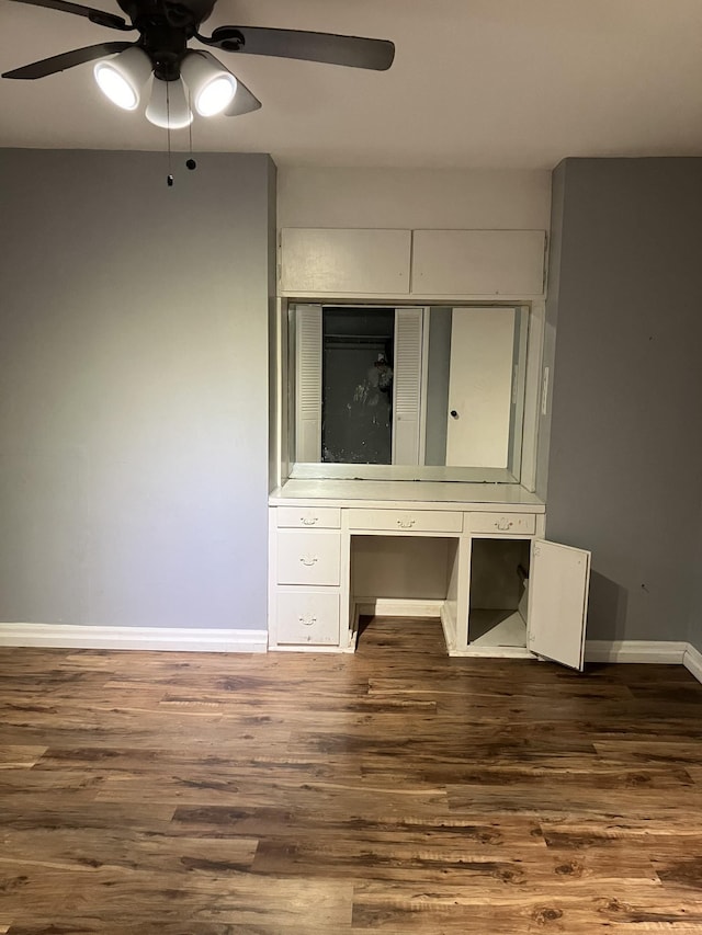 unfurnished bedroom featuring dark wood-type flooring, ceiling fan, and a closet