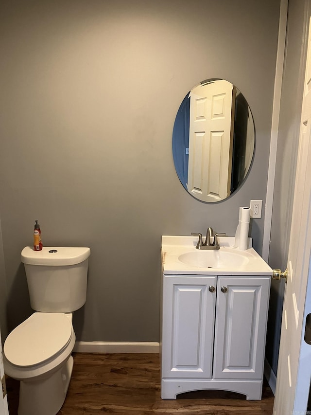 bathroom featuring hardwood / wood-style flooring, vanity, and toilet