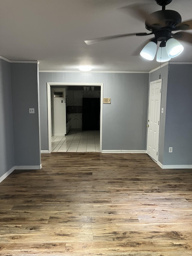 unfurnished room with crown molding, wood-type flooring, and ceiling fan