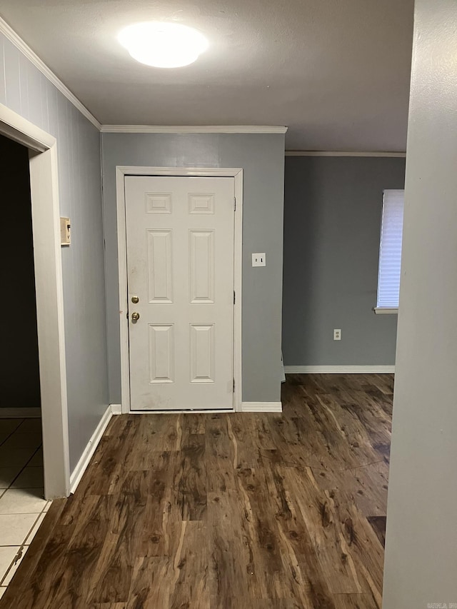 entryway featuring ornamental molding and dark hardwood / wood-style flooring