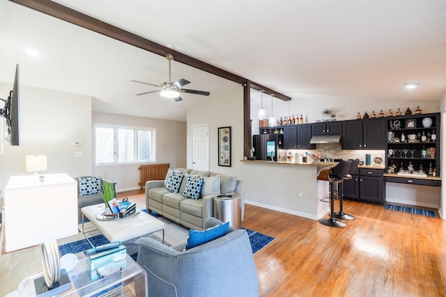 living room with lofted ceiling with beams, ceiling fan, radiator heating unit, and light hardwood / wood-style floors