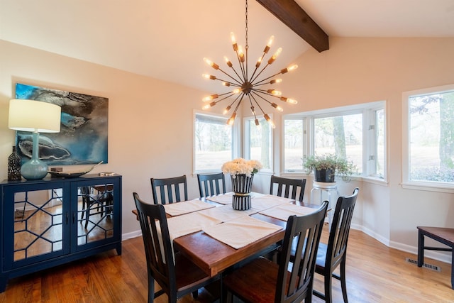 dining area with wood-type flooring, a chandelier, and vaulted ceiling with beams