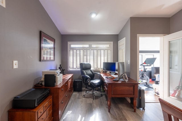 office featuring lofted ceiling and light hardwood / wood-style floors