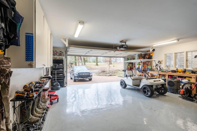 garage with a garage door opener and a workshop area