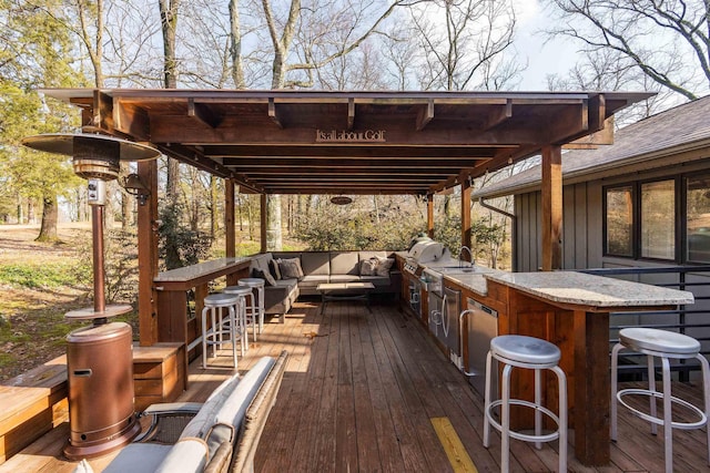 wooden terrace with an outdoor living space, exterior bar, and a grill