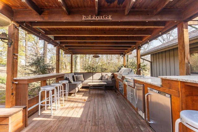 deck featuring exterior kitchen, outdoor lounge area, and area for grilling