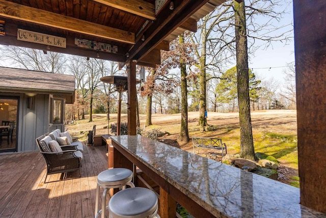 wooden deck with an outdoor bar