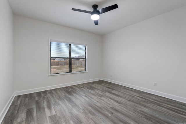 spare room featuring dark hardwood / wood-style floors and ceiling fan