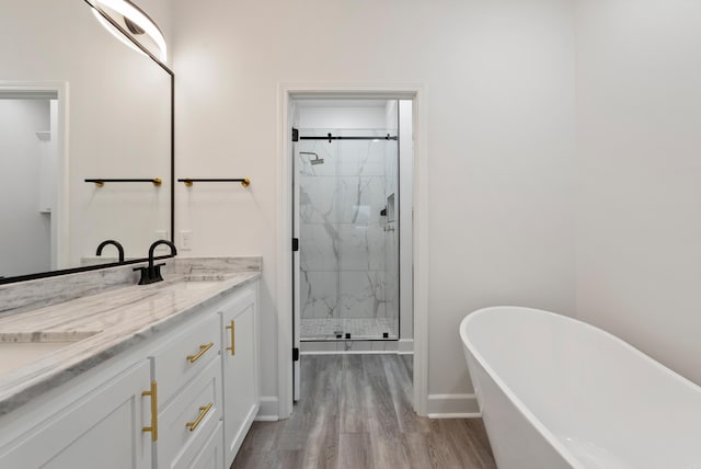 bathroom featuring vanity, wood-type flooring, and independent shower and bath