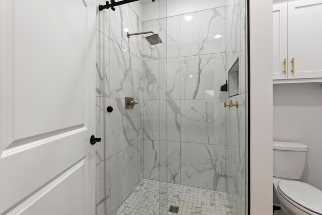 bathroom featuring walk in shower and toilet