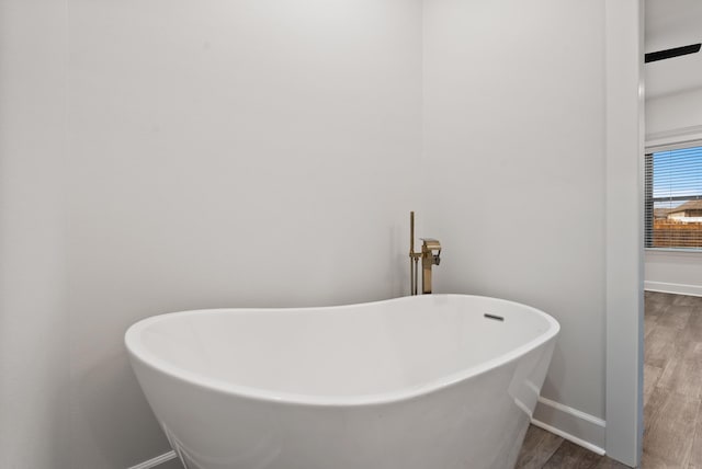 bathroom featuring hardwood / wood-style flooring and a tub