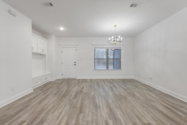 interior space with a chandelier and light hardwood / wood-style flooring