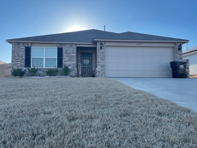 ranch-style home with a garage and a front yard