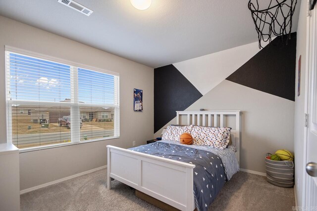 carpeted bedroom with lofted ceiling