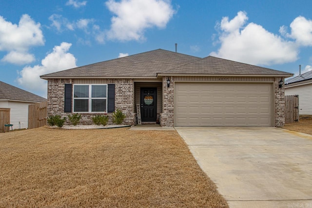 ranch-style house with a garage and a front yard