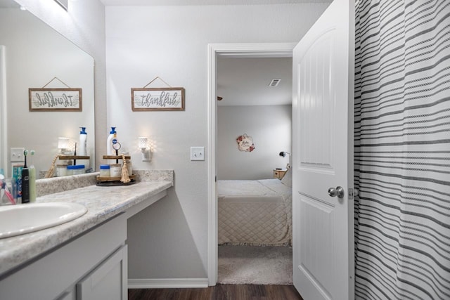 bathroom with vanity and hardwood / wood-style floors