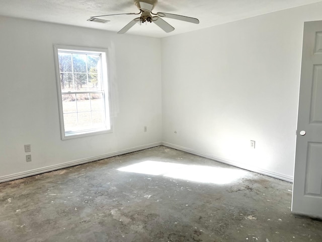 empty room with concrete floors and ceiling fan