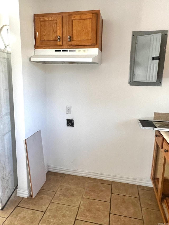 laundry area featuring light tile patterned floors and electric panel