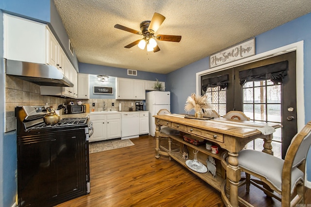 kitchen with sink, white cabinets, dark hardwood / wood-style flooring, ceiling fan, and white appliances