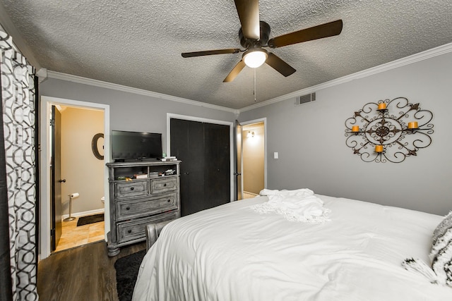 bedroom featuring dark wood-type flooring, ceiling fan, crown molding, and a textured ceiling