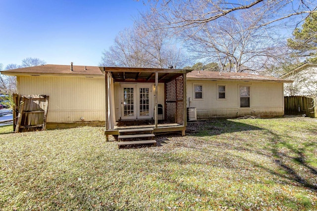 back of property with french doors and a yard