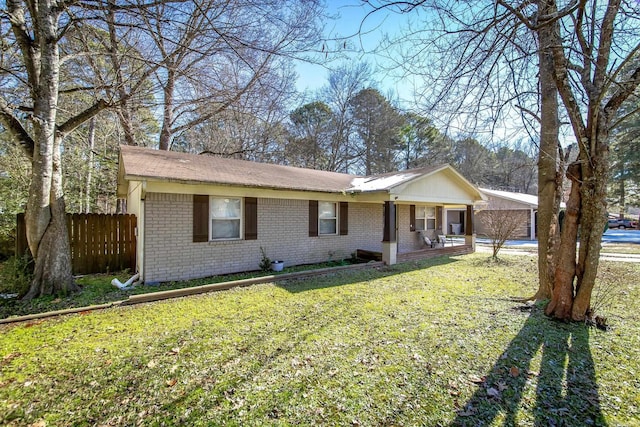 ranch-style home with a front yard and covered porch