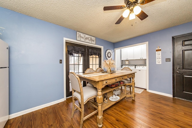 dining area with ceiling fan, dark hardwood / wood-style flooring, washing machine and dryer, and a textured ceiling