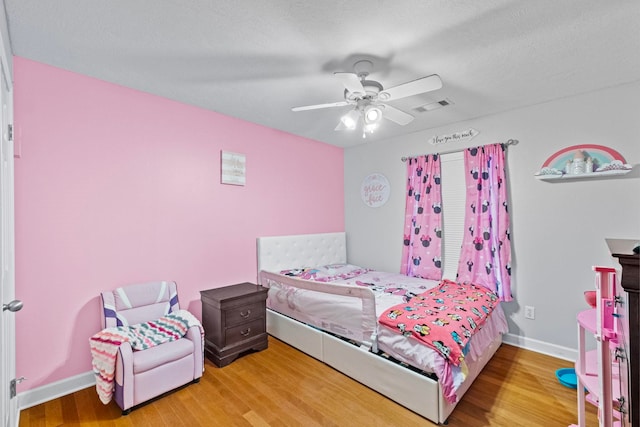 bedroom with ceiling fan and hardwood / wood-style floors