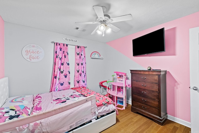 bedroom with lofted ceiling, ceiling fan, and light hardwood / wood-style flooring