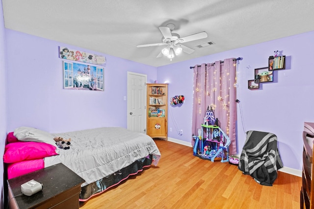 bedroom featuring hardwood / wood-style flooring and ceiling fan