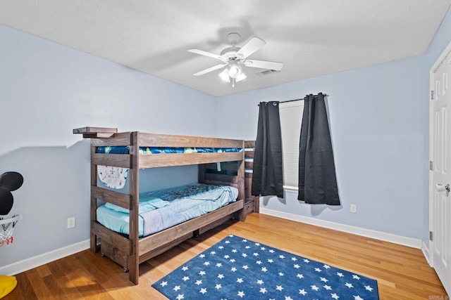 bedroom with wood-type flooring and ceiling fan