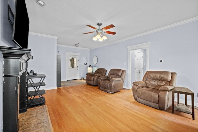 living room featuring crown molding, hardwood / wood-style floors, and ceiling fan