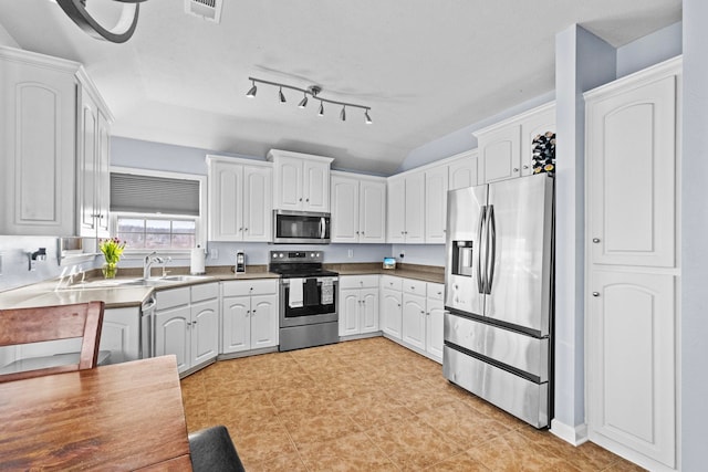 kitchen featuring white cabinetry, stainless steel appliances, and sink