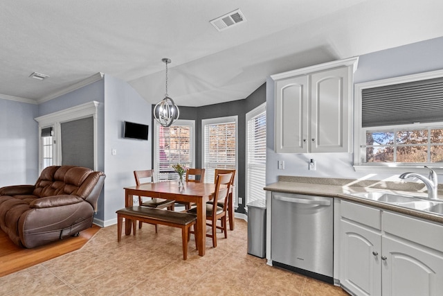 tiled dining area with an inviting chandelier, lofted ceiling, sink, and a wealth of natural light