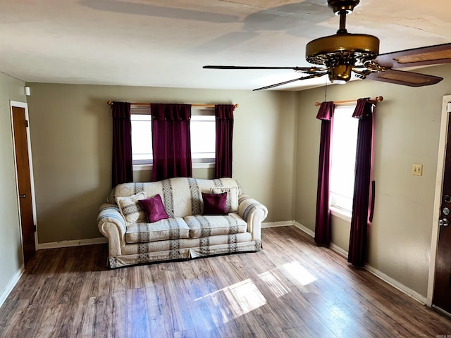 living room featuring hardwood / wood-style floors and ceiling fan