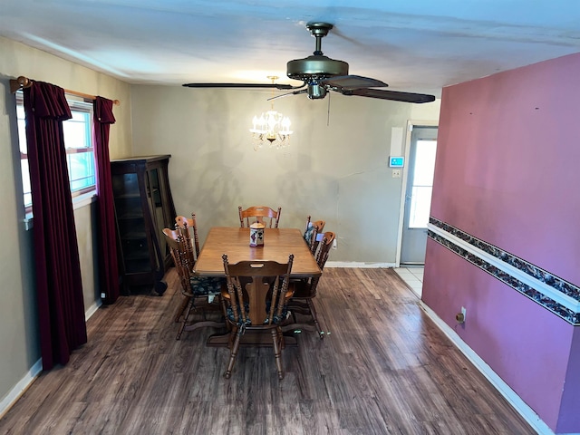 dining room with an inviting chandelier and dark wood-type flooring