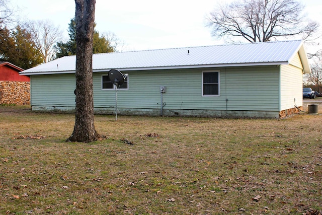 back of property featuring a yard