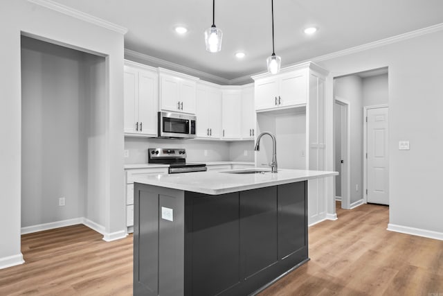 kitchen with stainless steel appliances, sink, hanging light fixtures, and white cabinets