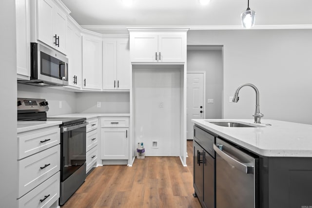 kitchen with stainless steel appliances, sink, and white cabinets