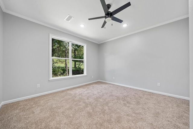 spare room with crown molding, ceiling fan, and carpet