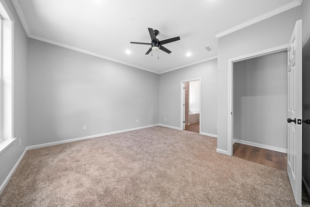 unfurnished bedroom with ornamental molding, carpet floors, connected bathroom, and ceiling fan